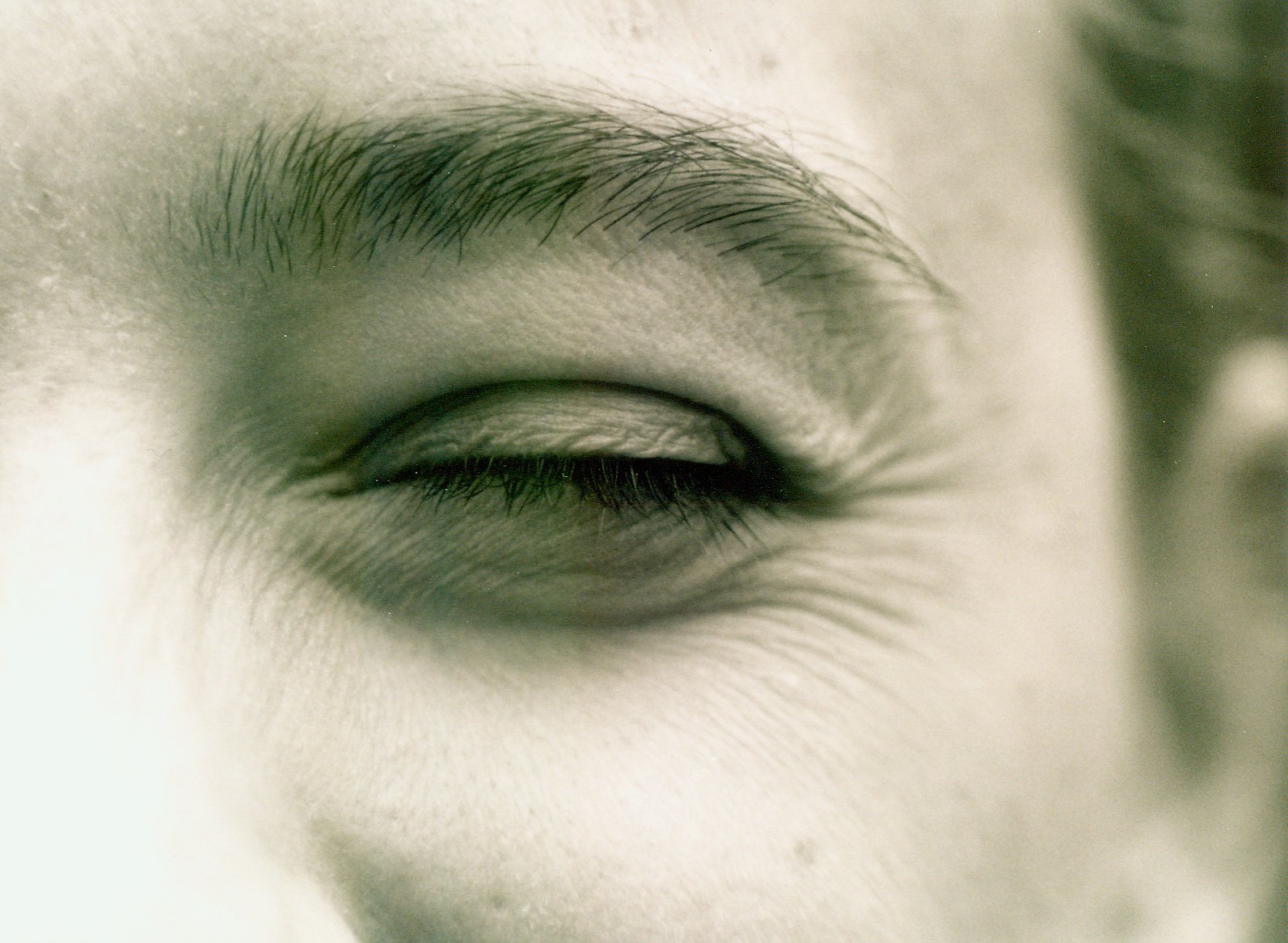 a man's face with a blurry eyeball