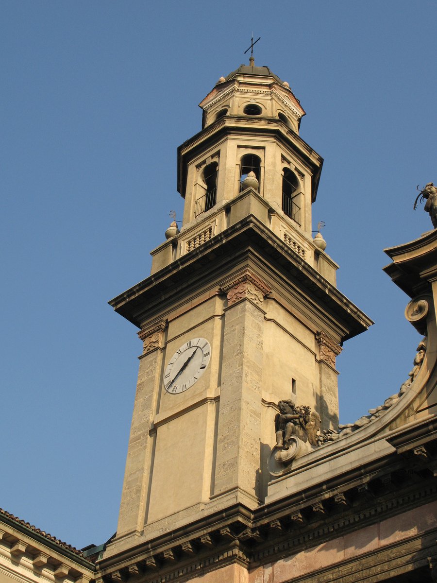 a stone building has a tall tower with clocks on it