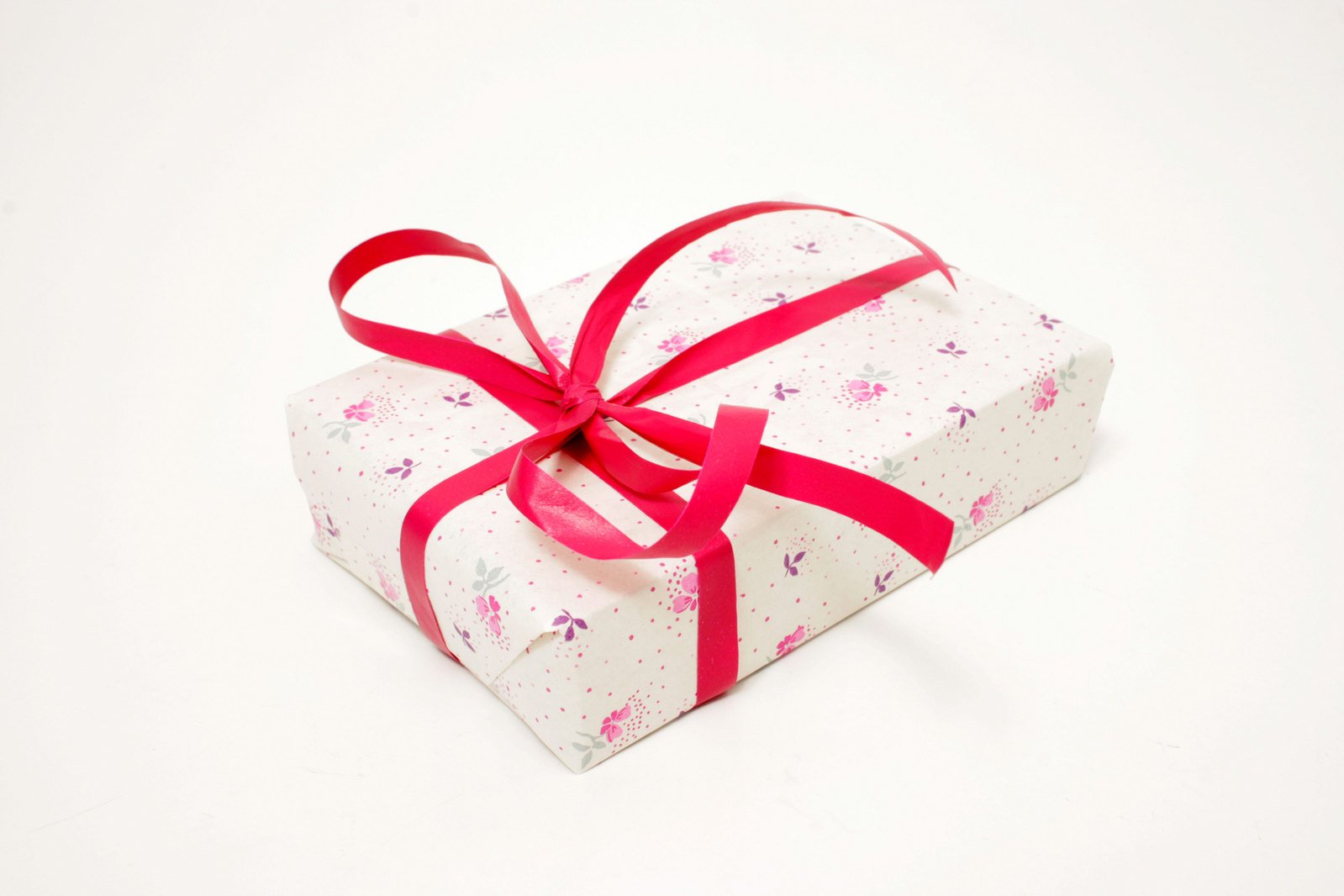 a small heart shaped gift box with a ribbon on it