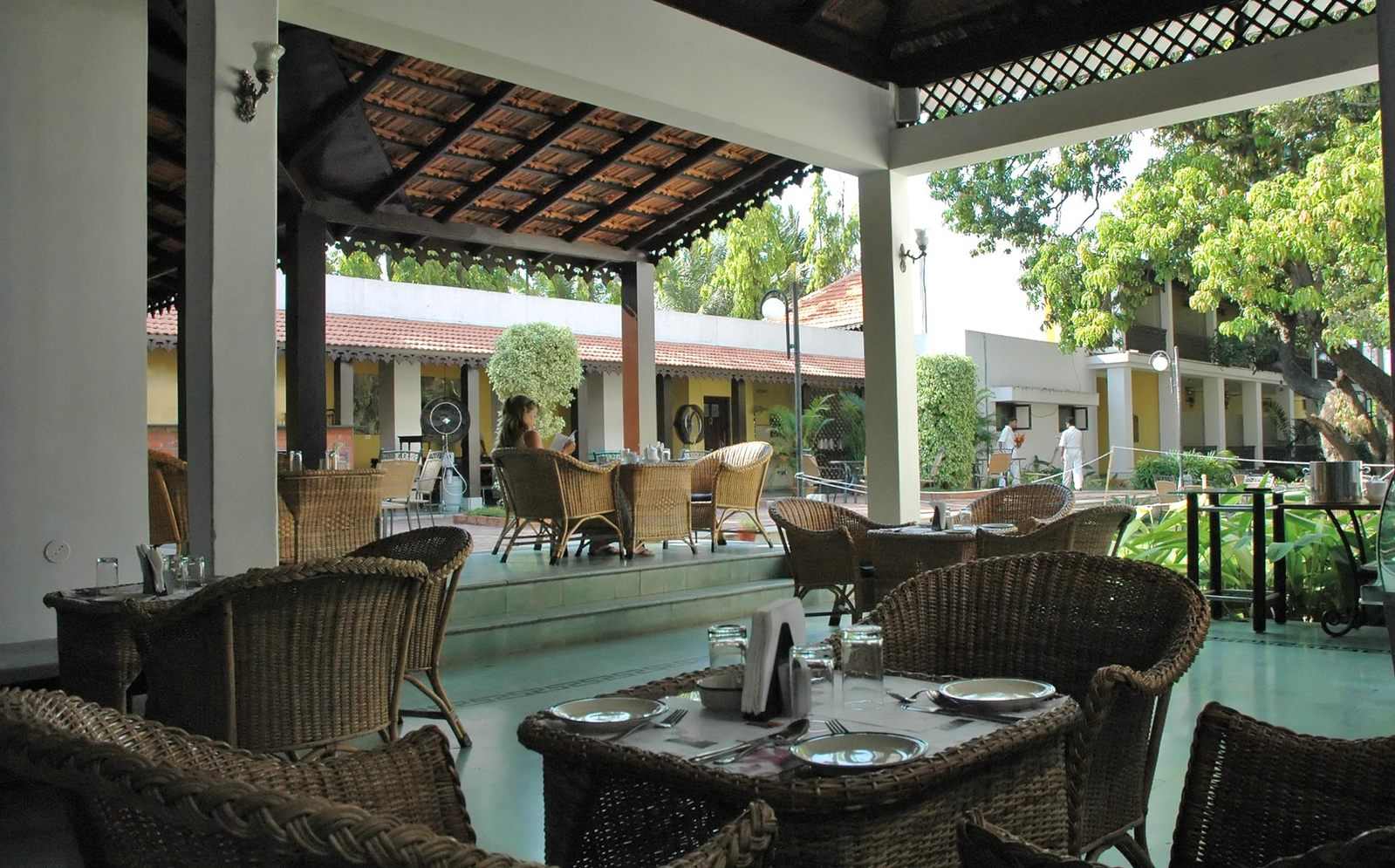 a number of chairs on a patio with a table in front of them