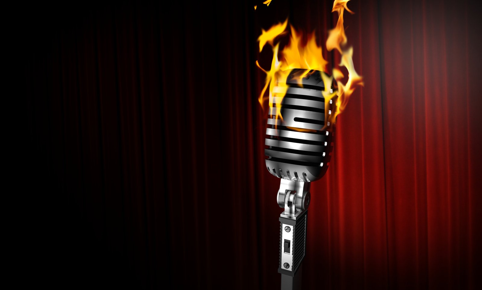 a microphone on a stage with some bright flames