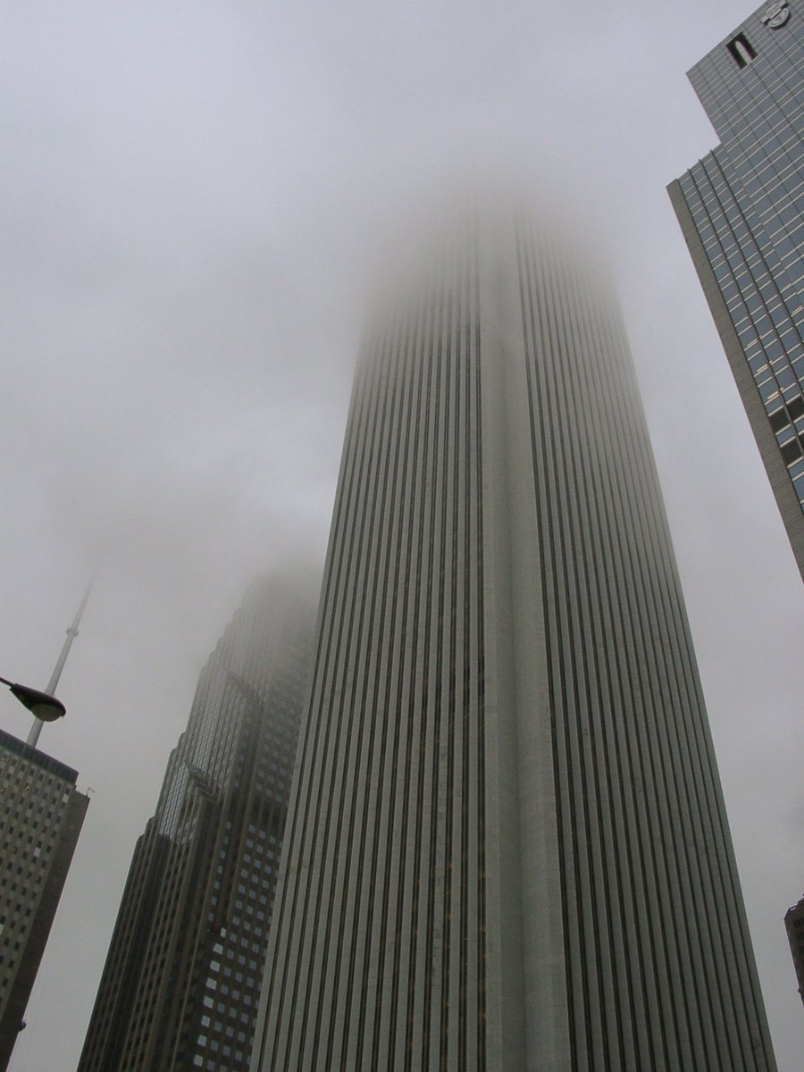 some tall buildings on a foggy day