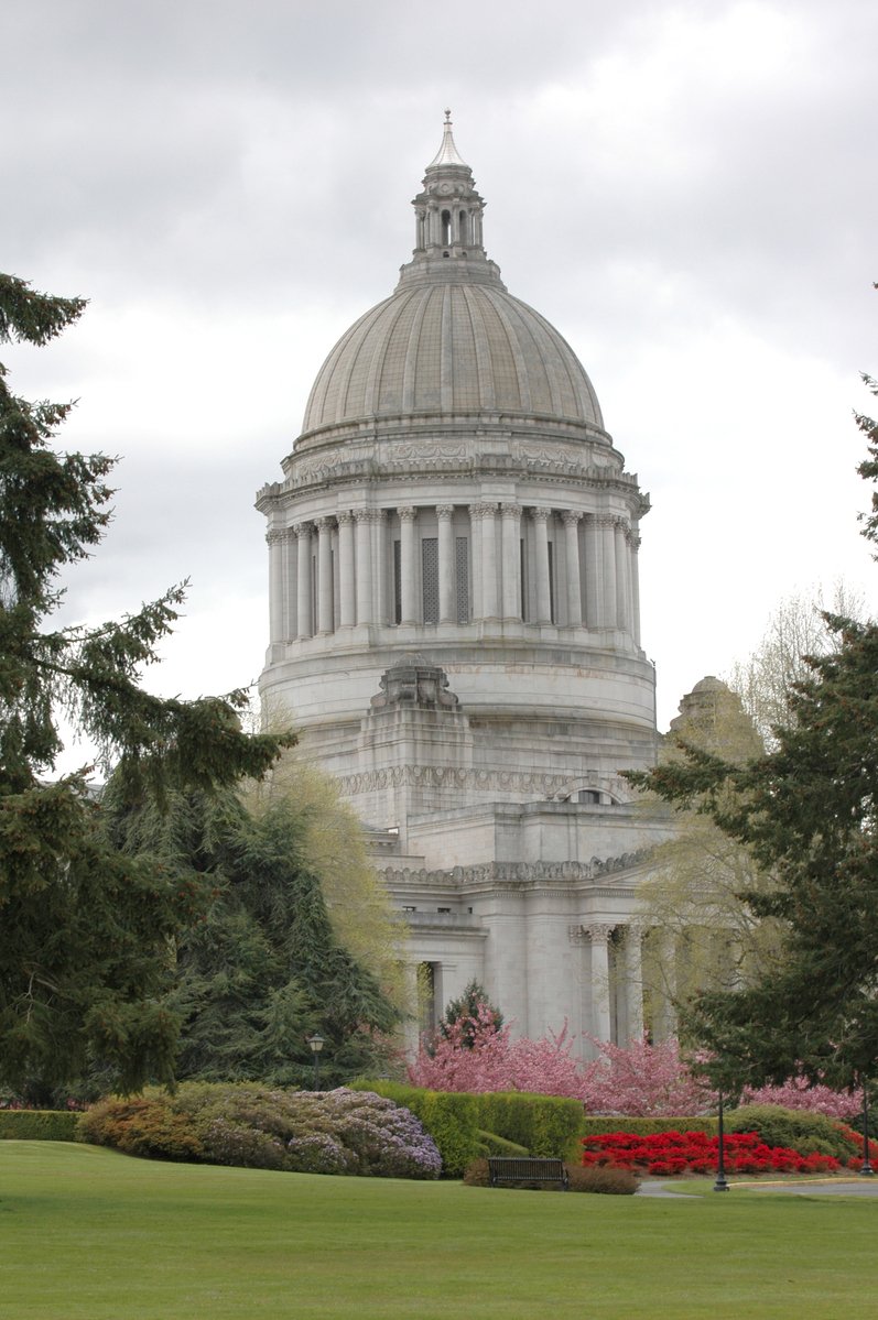 a tall white building with a domed top