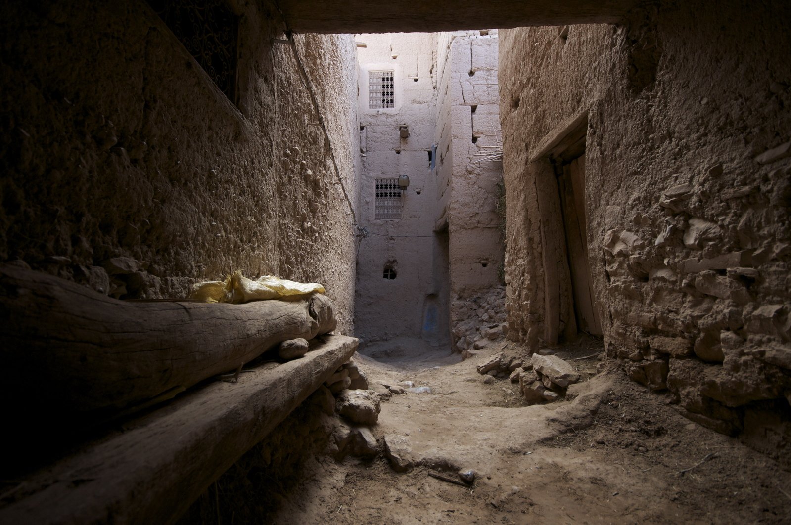 an alley with stone walls and dirt floors