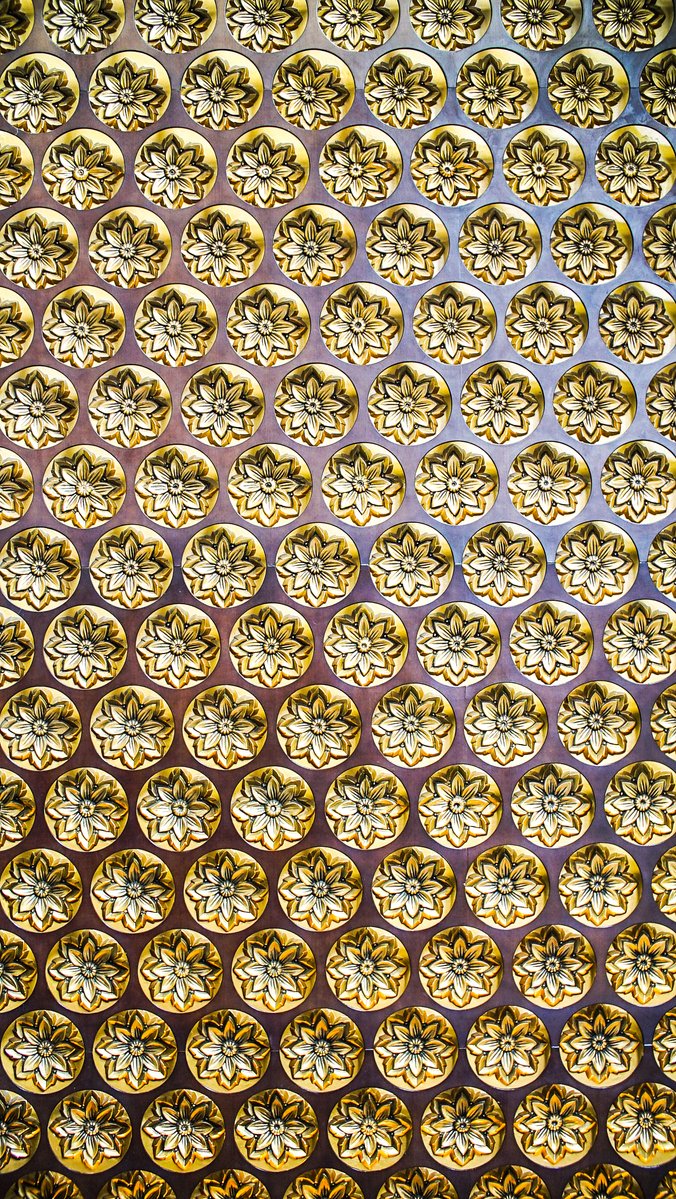 golden circles are arranged over an abstract pattern