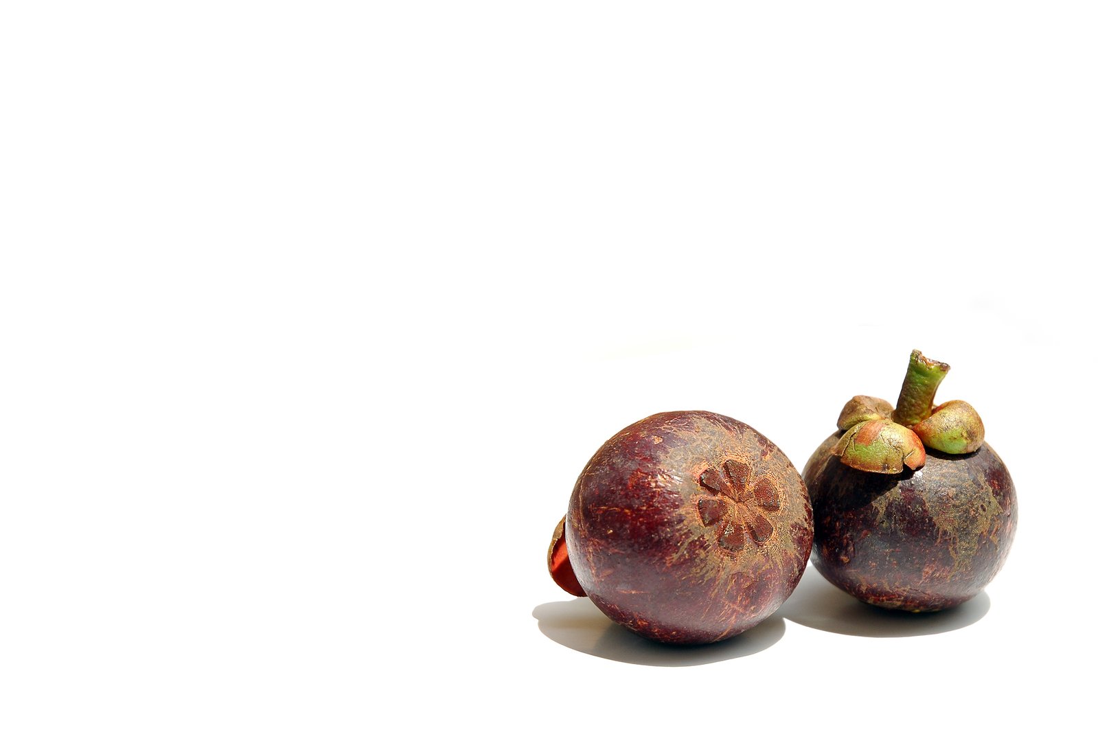 two mangos sitting next to each other on a table