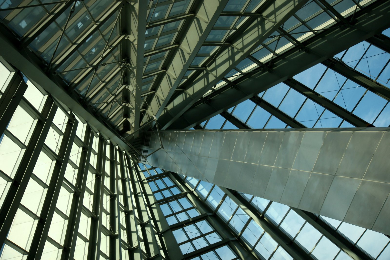 looking up at a large modern glass building