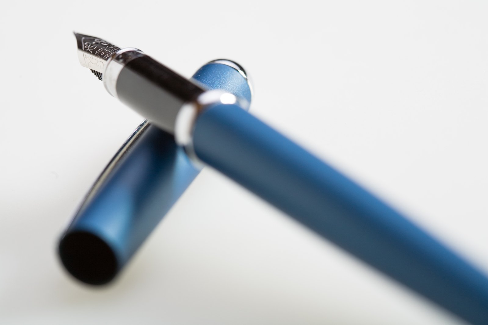 there is a very large blue and silver pen with a pointed tip