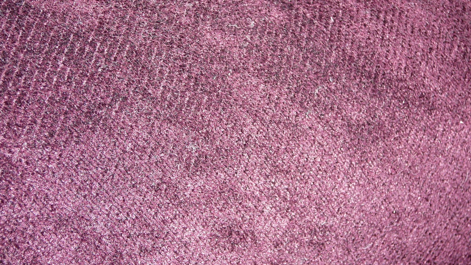 the background of a textured purple fabric texture