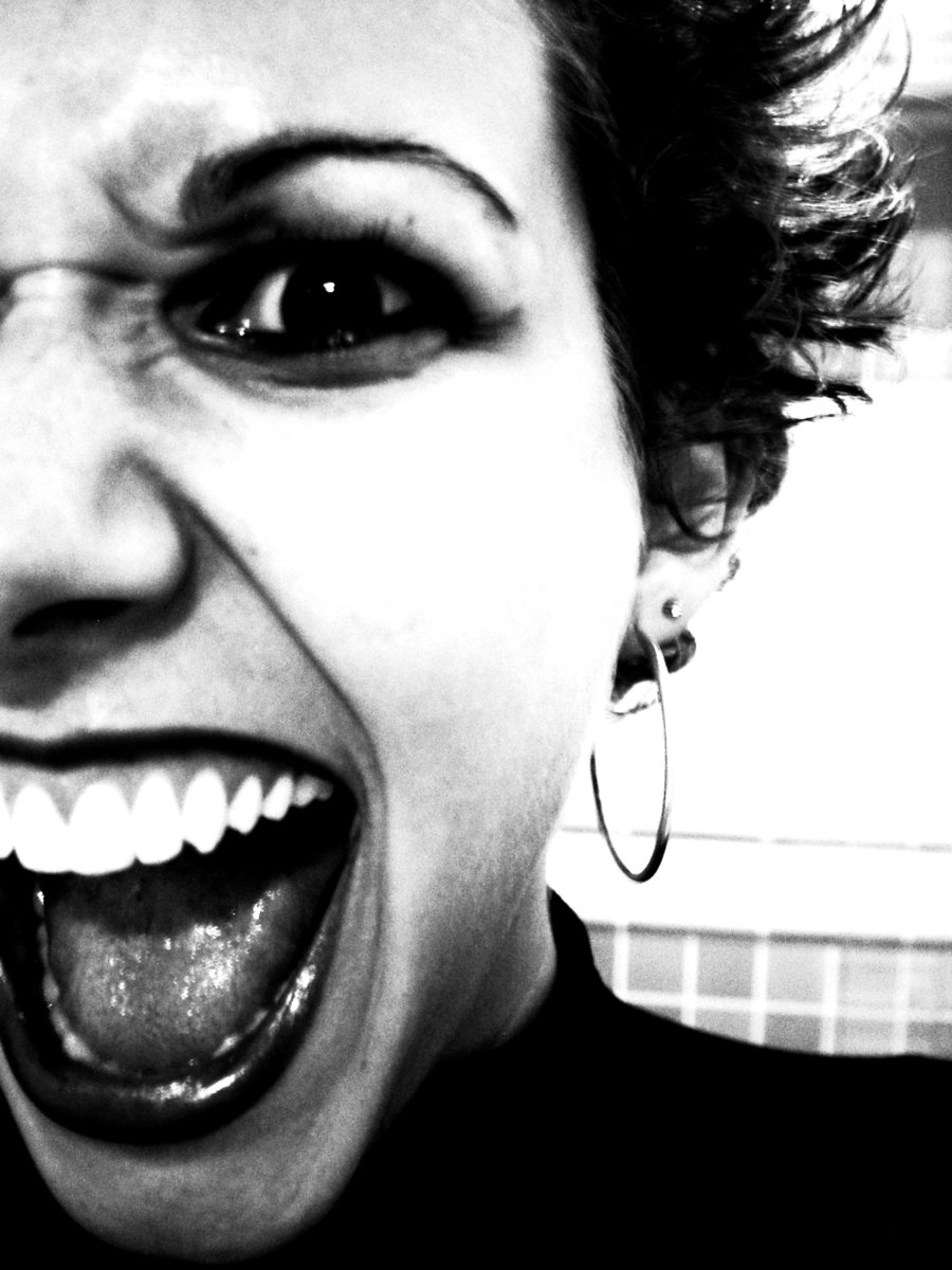 woman wearing big round earrings smiling in black and white