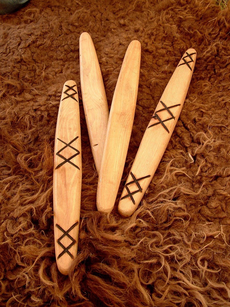 three wooden surf boards laying in the sand