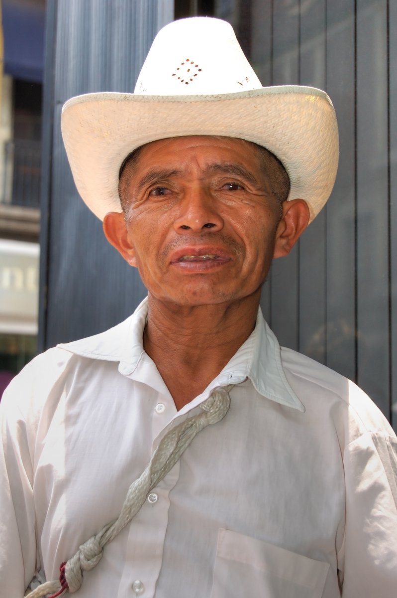 a man wearing a white hat and a rope