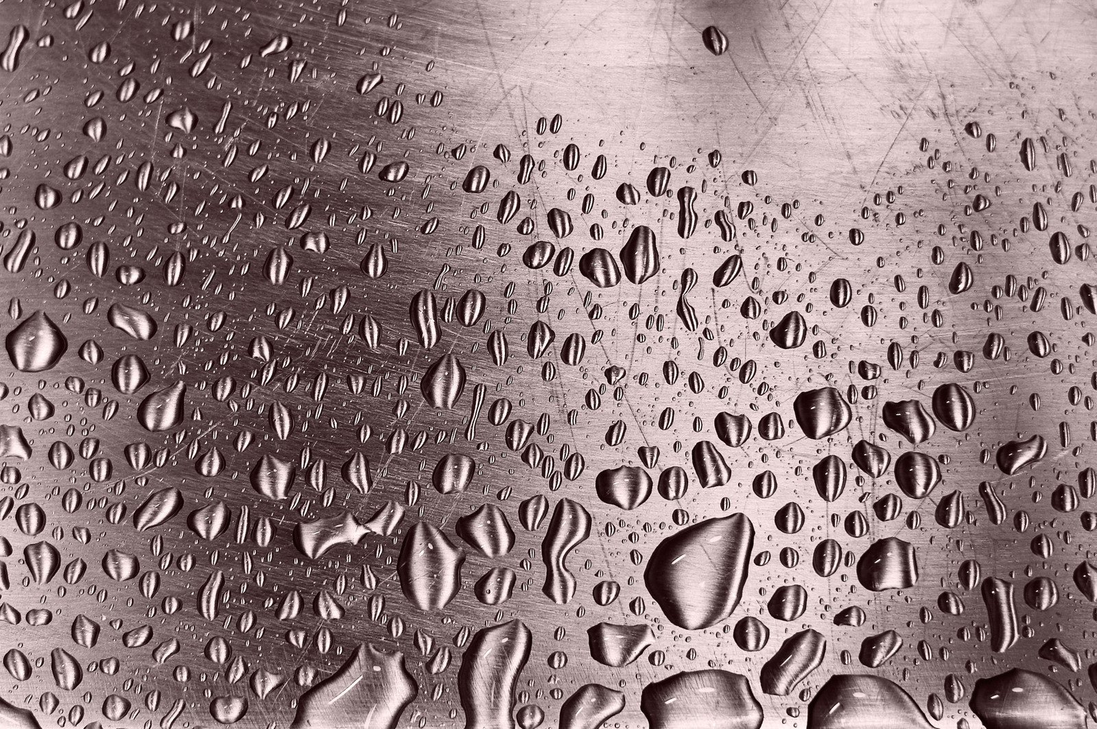 close up of water drops on a metal container
