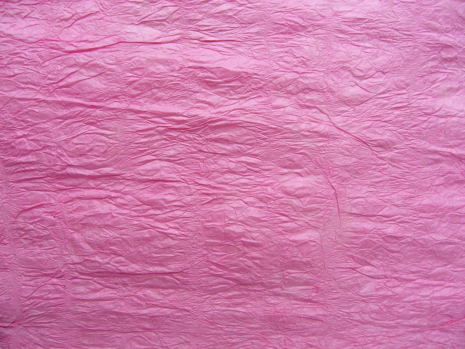 a pink surface is covered in small layers