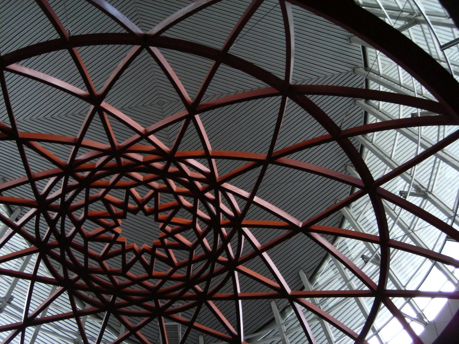 circular metal structure with metal bars and glass ceiling