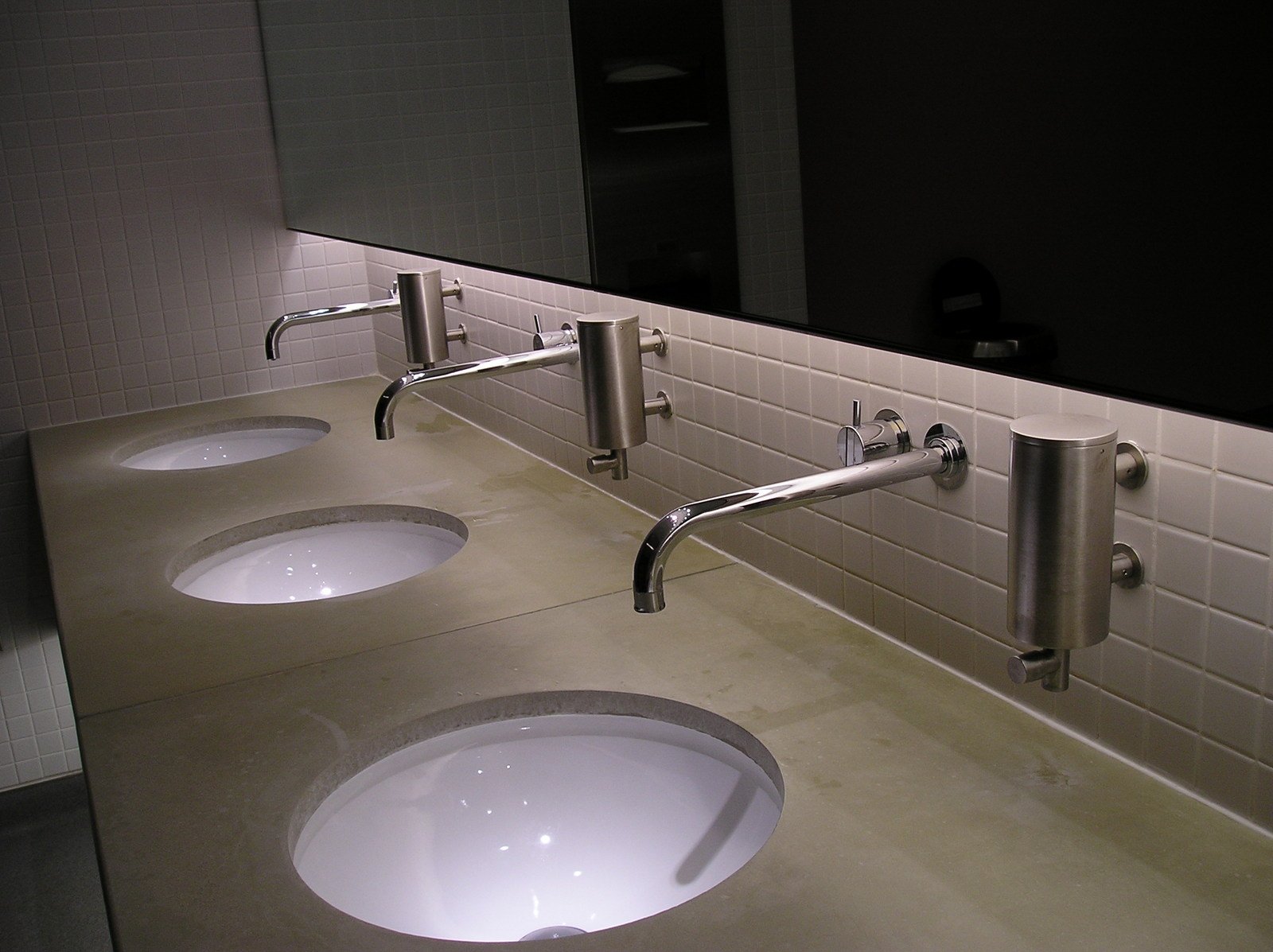 a public restroom with sinks and mirrors
