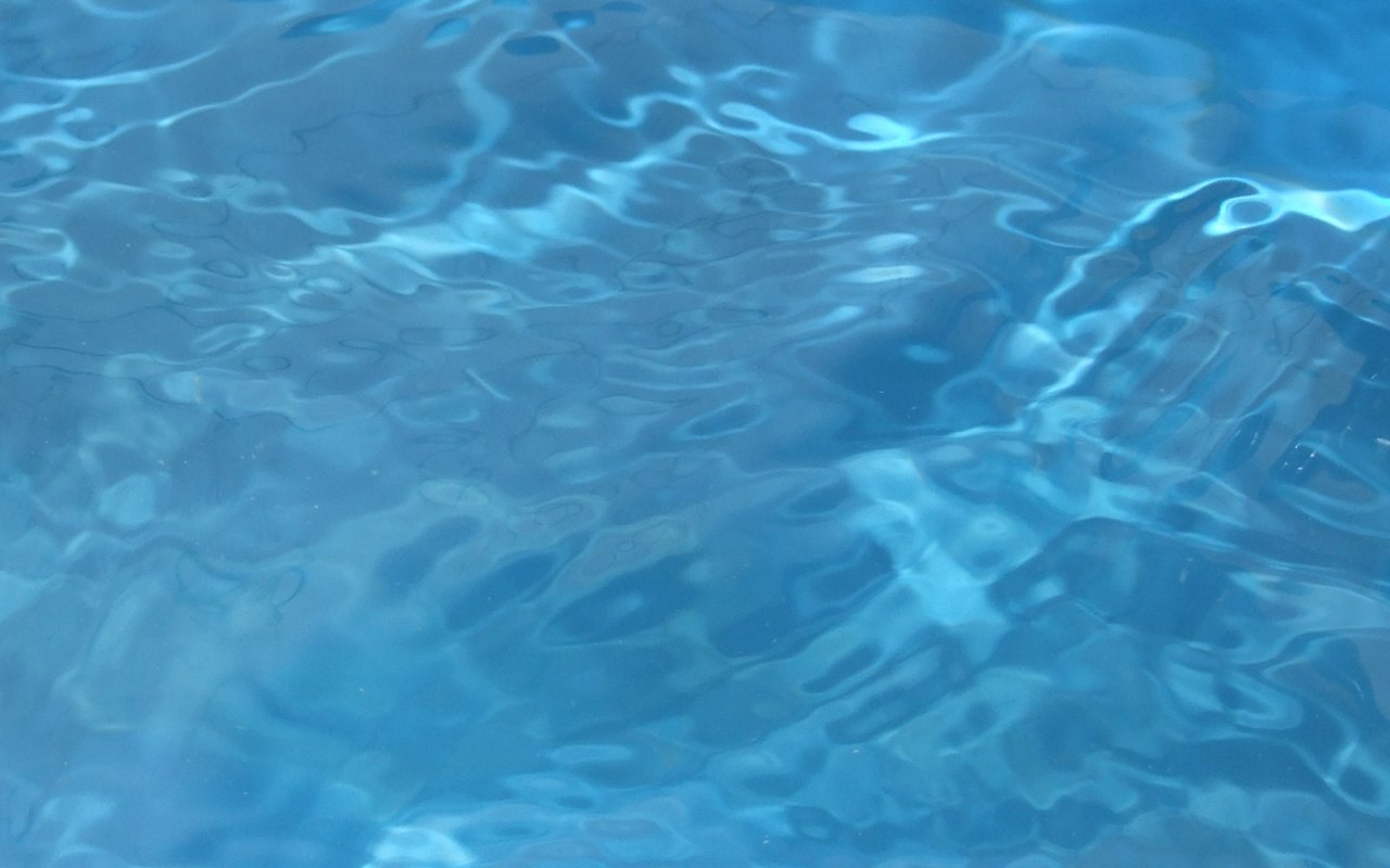 a blue pool with water textureing the surface
