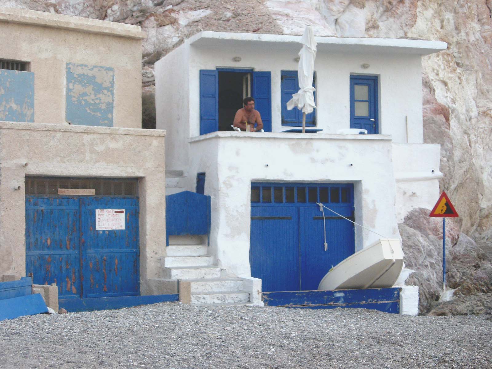 a house is in the foreground with blue doors and steps