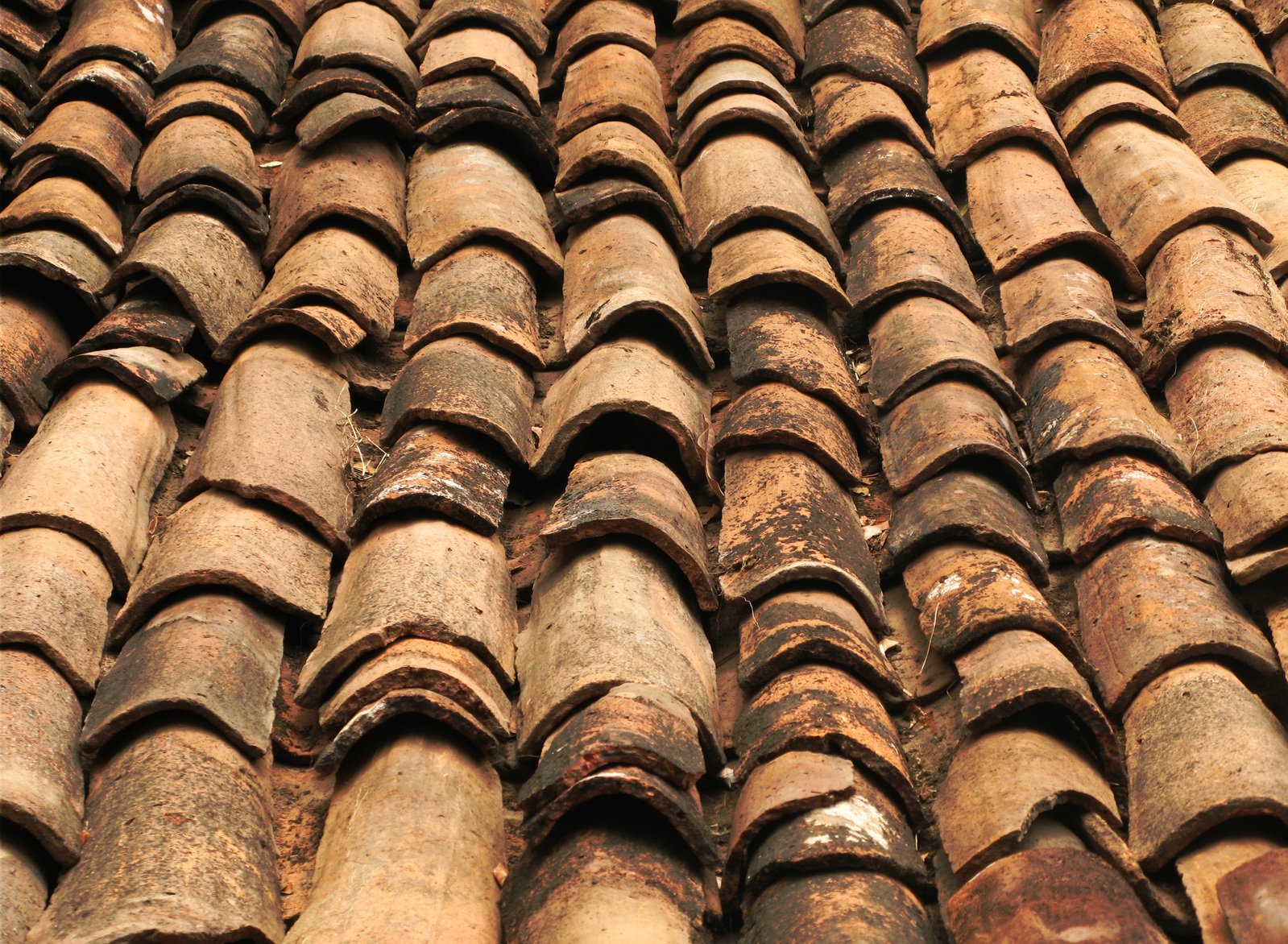 a large pile of old tile roof tiles