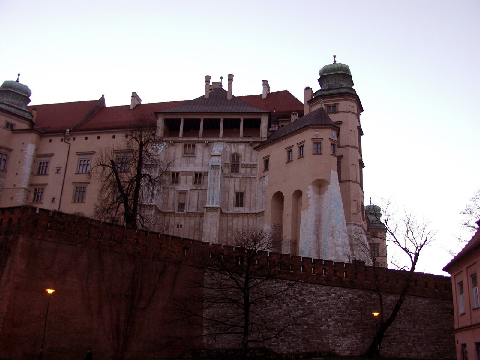 the castle is on top of a large rock wall