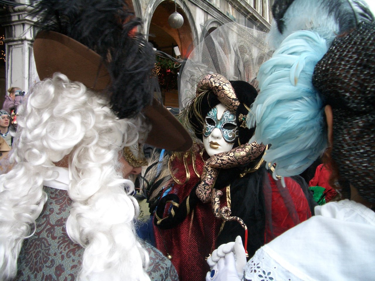 a person wearing a face mask is surrounded by wigs