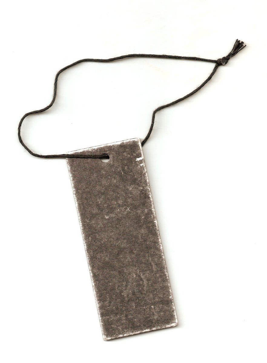 an old gray card on a string with a tassel