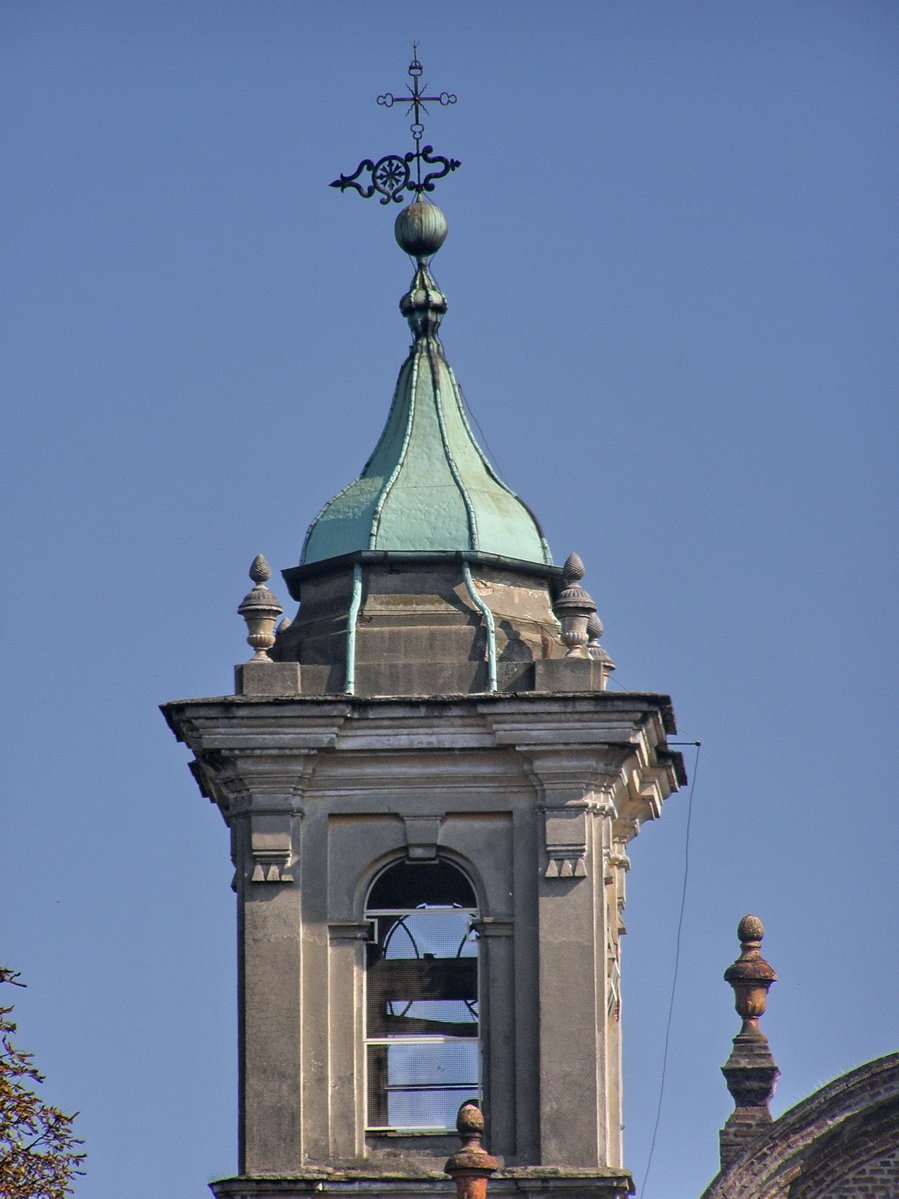 a tall clock tower sitting next to a cloudy blue sky