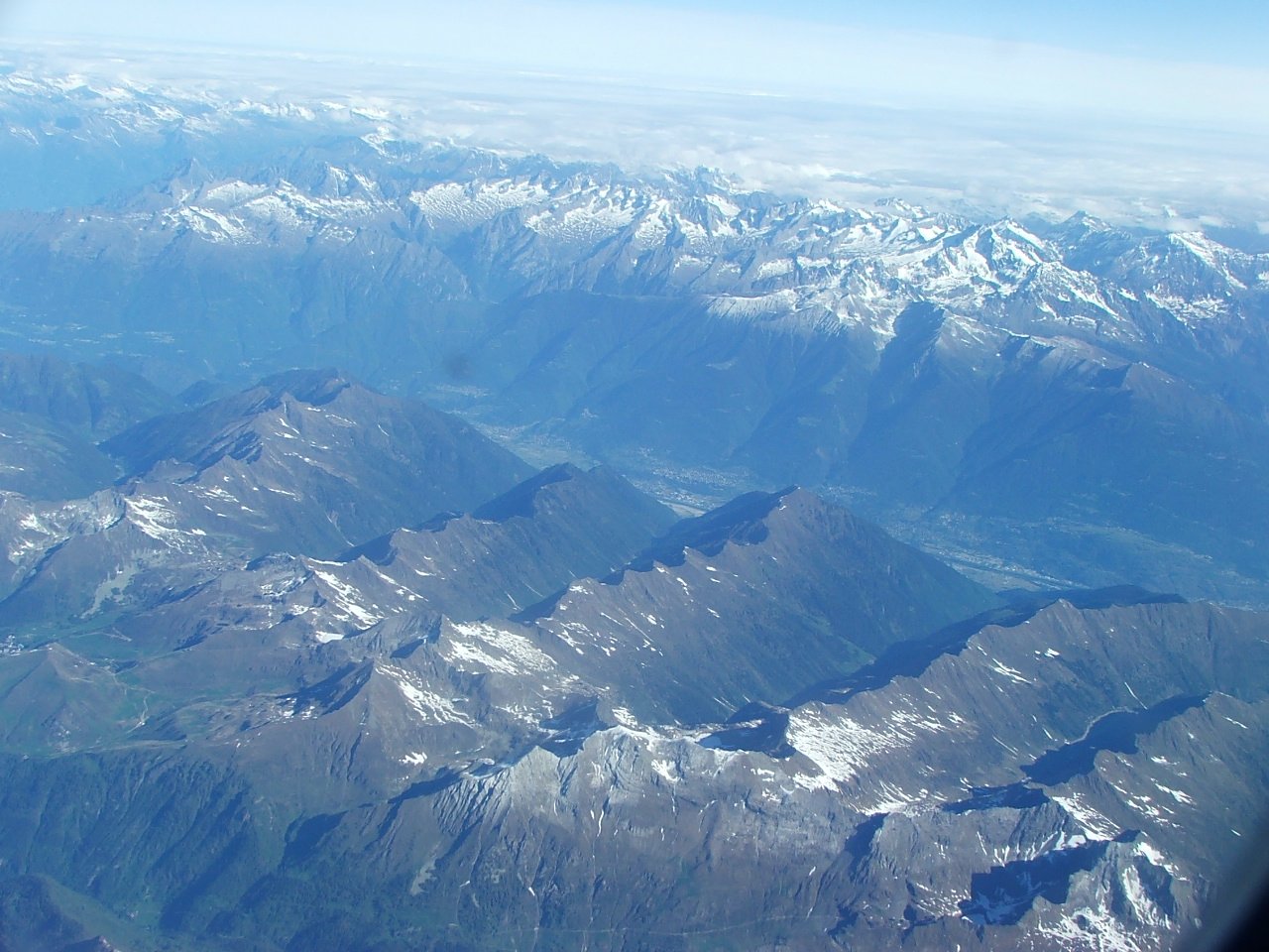 an aerial po taken from inside a plane shows the mountains