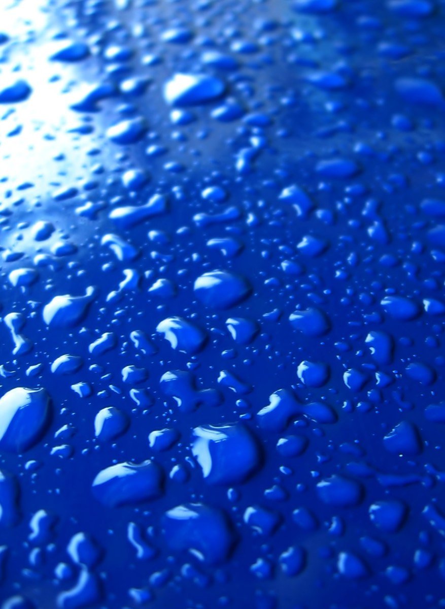 a blue background with many water drops