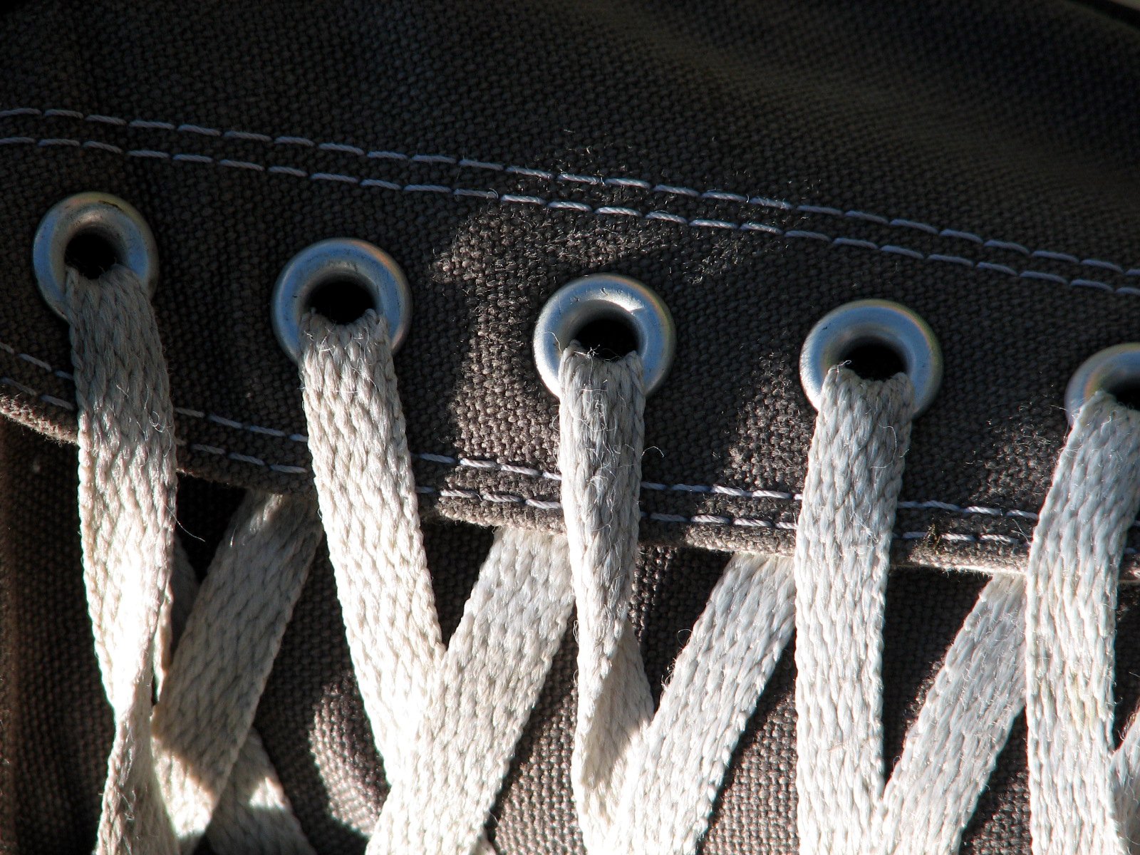 a group of identical handles with gray and white thread attached