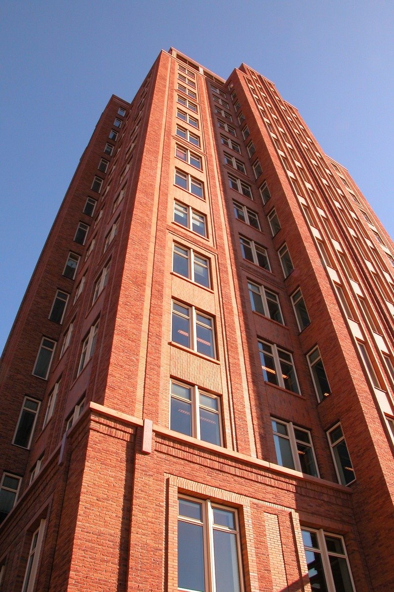 a tall red brick building with several windows