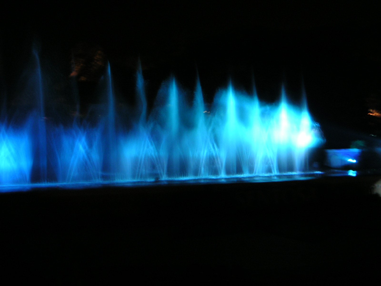 the water is illuminated and is moving at night