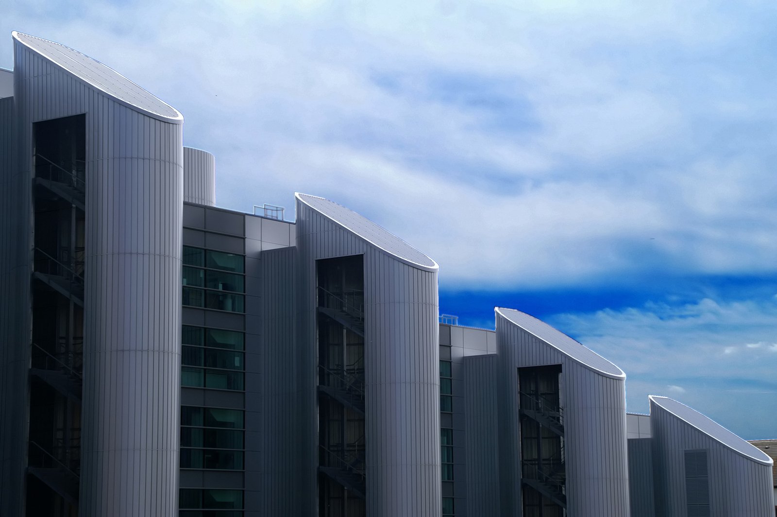 a couple of large buildings with sky in the background