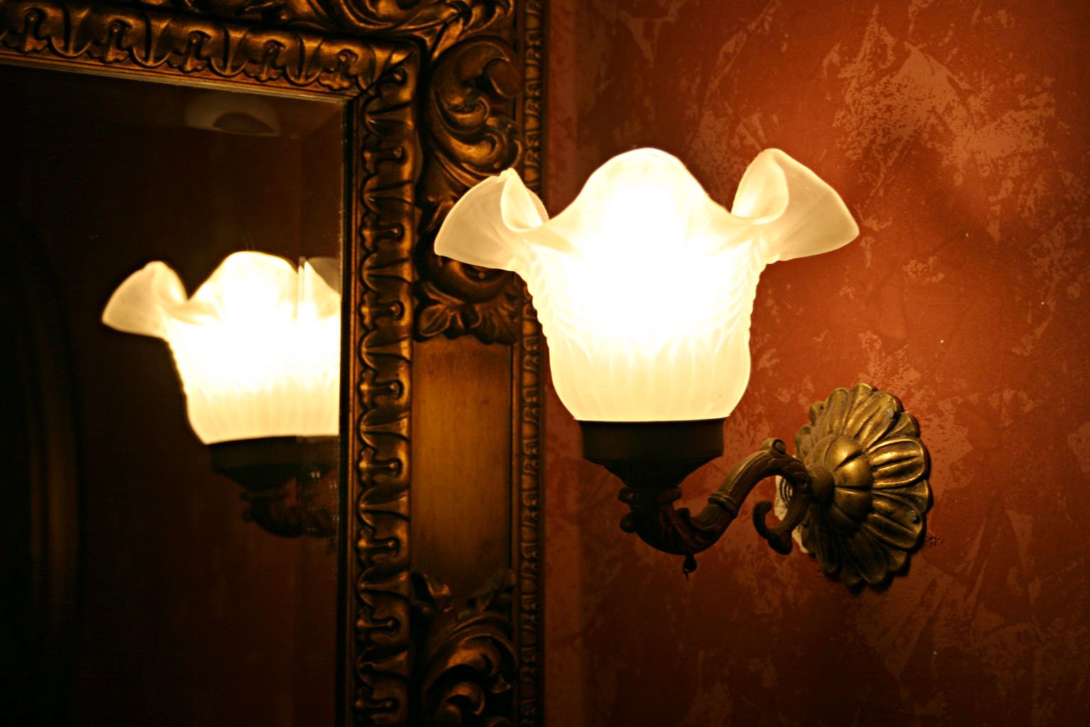 a close up of a wall light in a bathroom