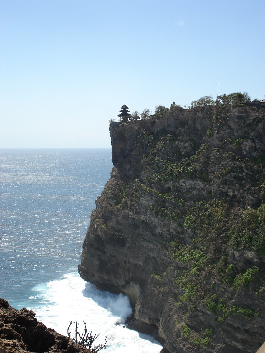 a cliff next to the ocean and water