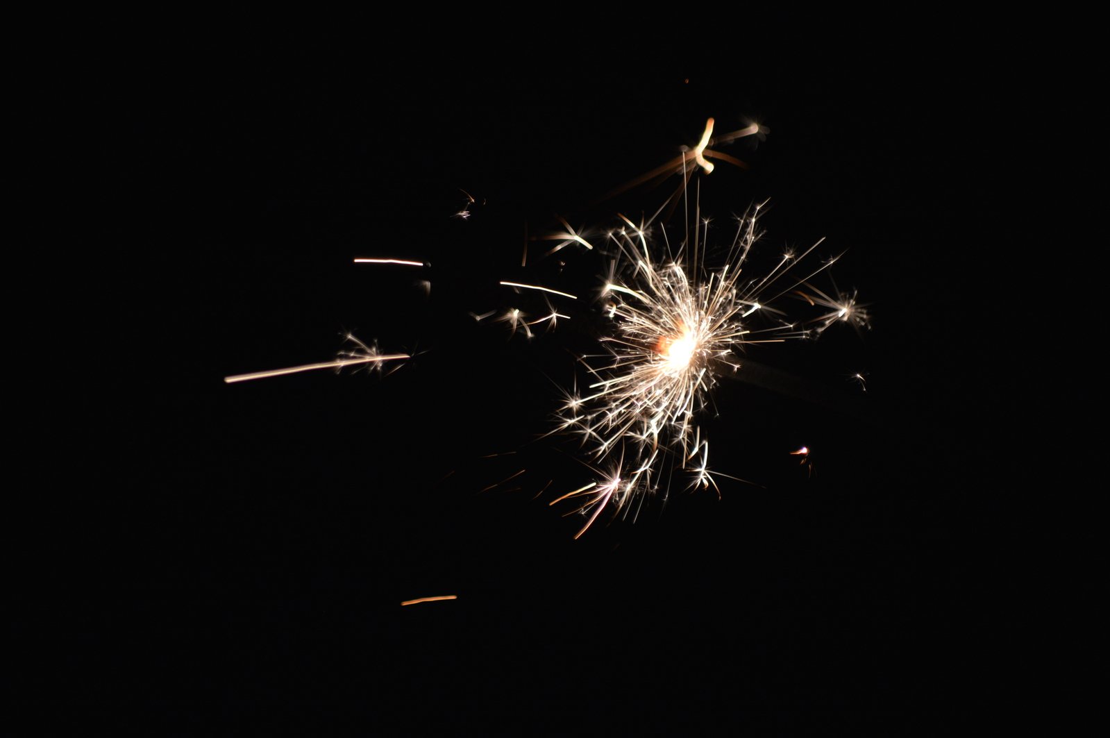 a close up view of sparklers on black background