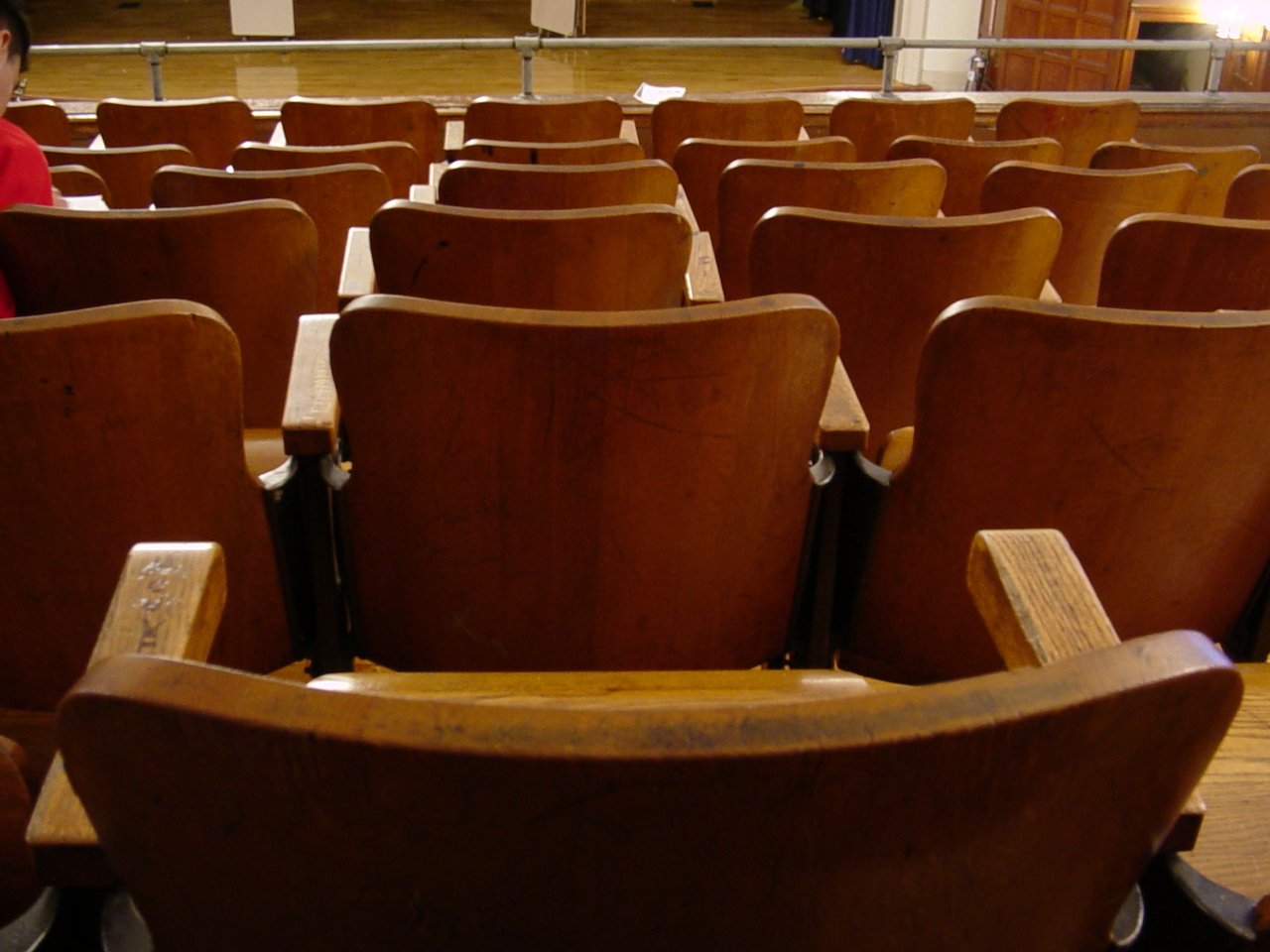 rows of empty seats are arranged at the front of the auditorium