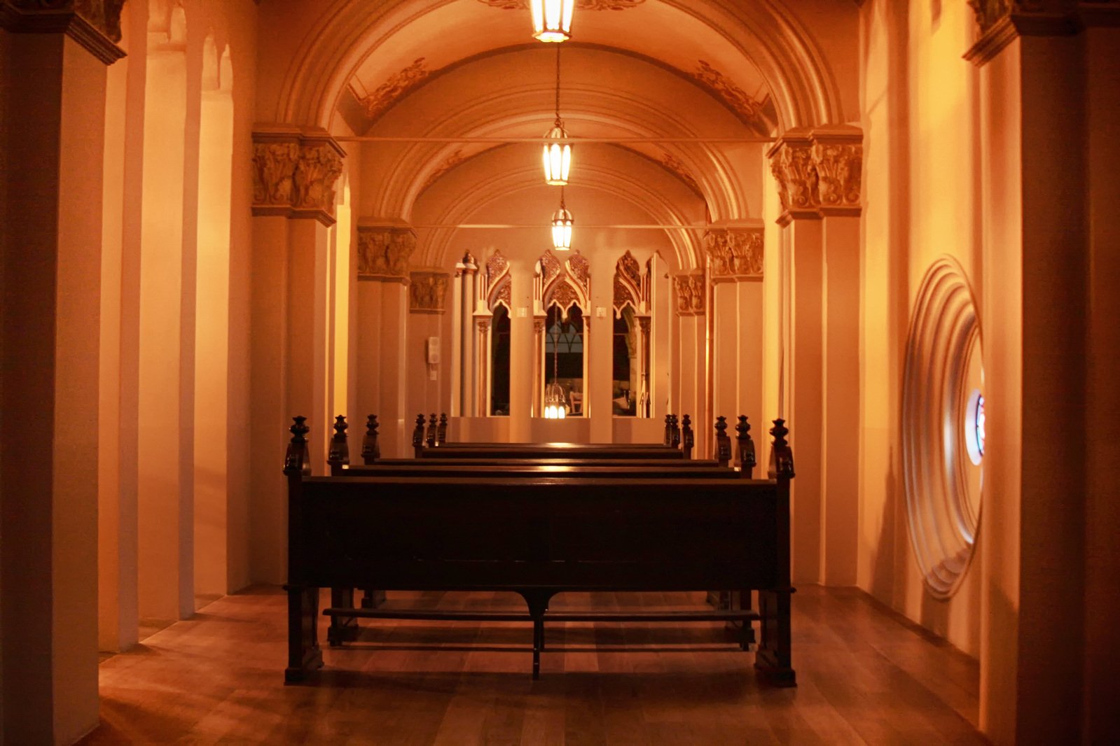 an empty church with pews in the center