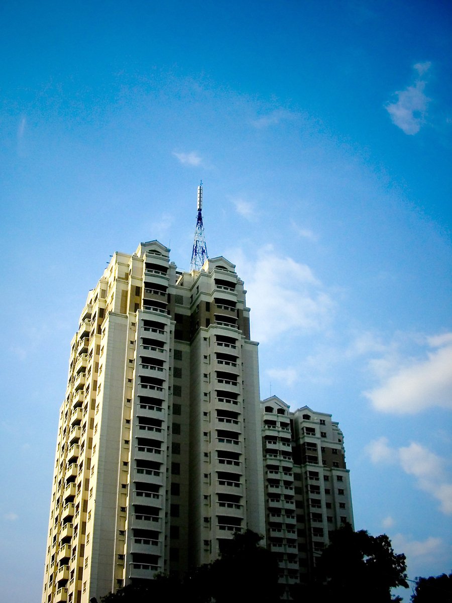 an apartment building in an urban area, against a blue sky
