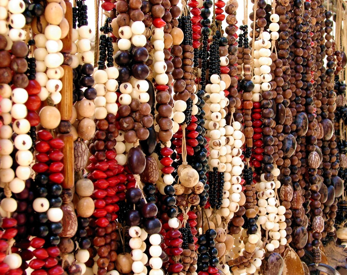 a rack full of many beads with red and white designs