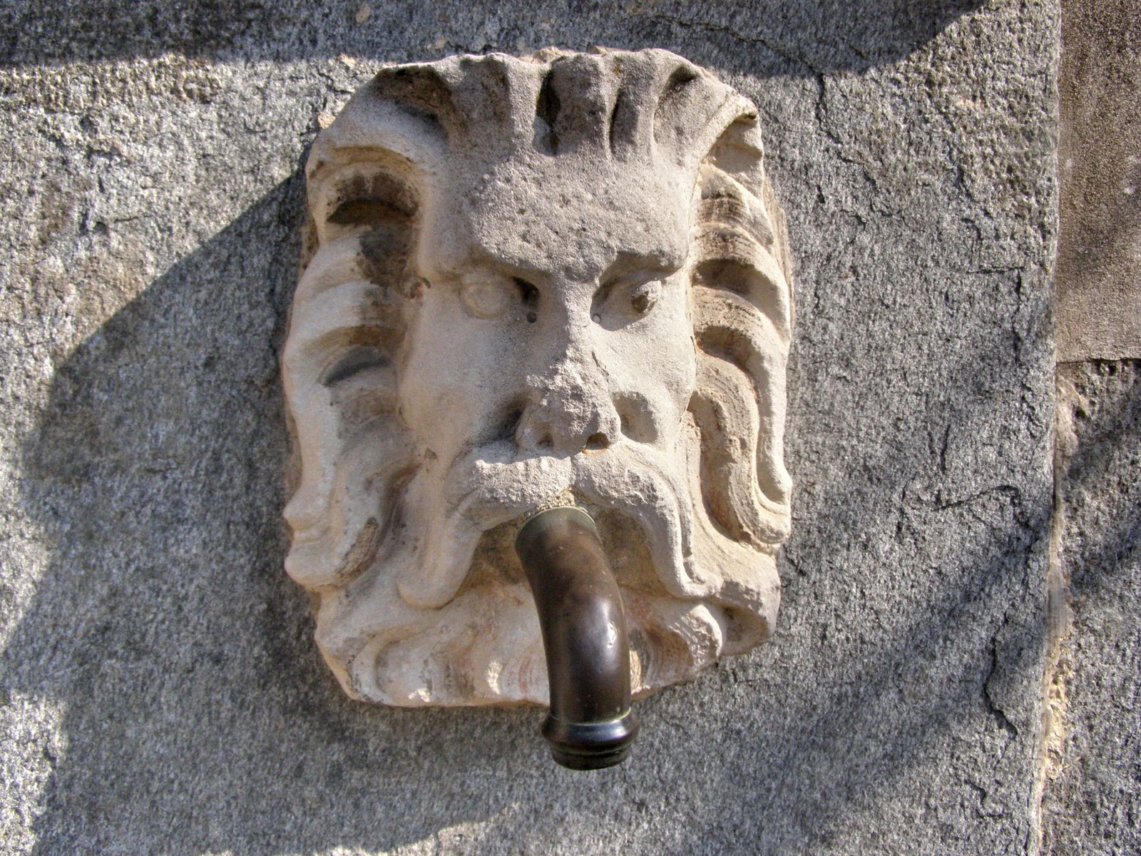 an interesting stone object with a pipe sticking out of it