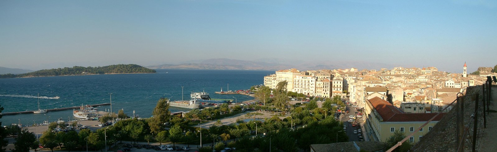 a view of a city, a harbor and several boats