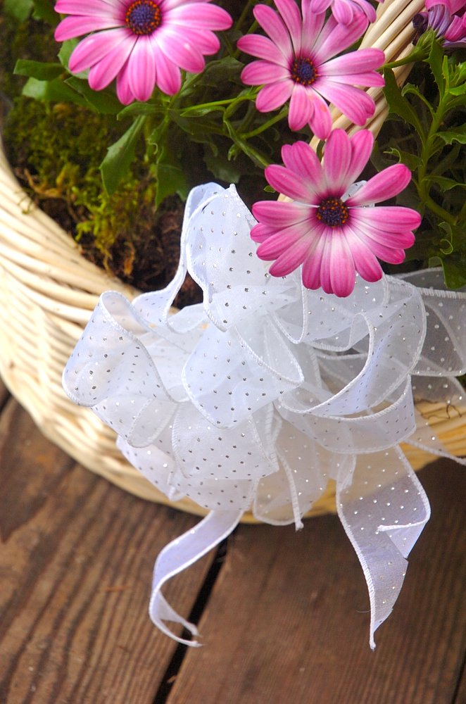 flowers are arranged in a basket next to the handles