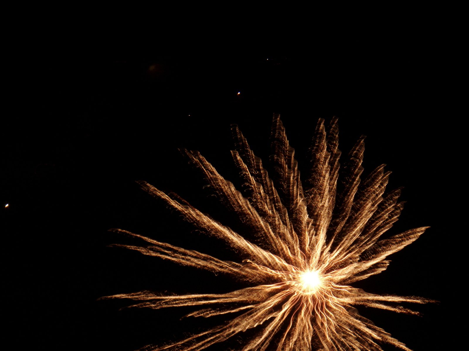 fireworks bursting up in the night sky during a celetion