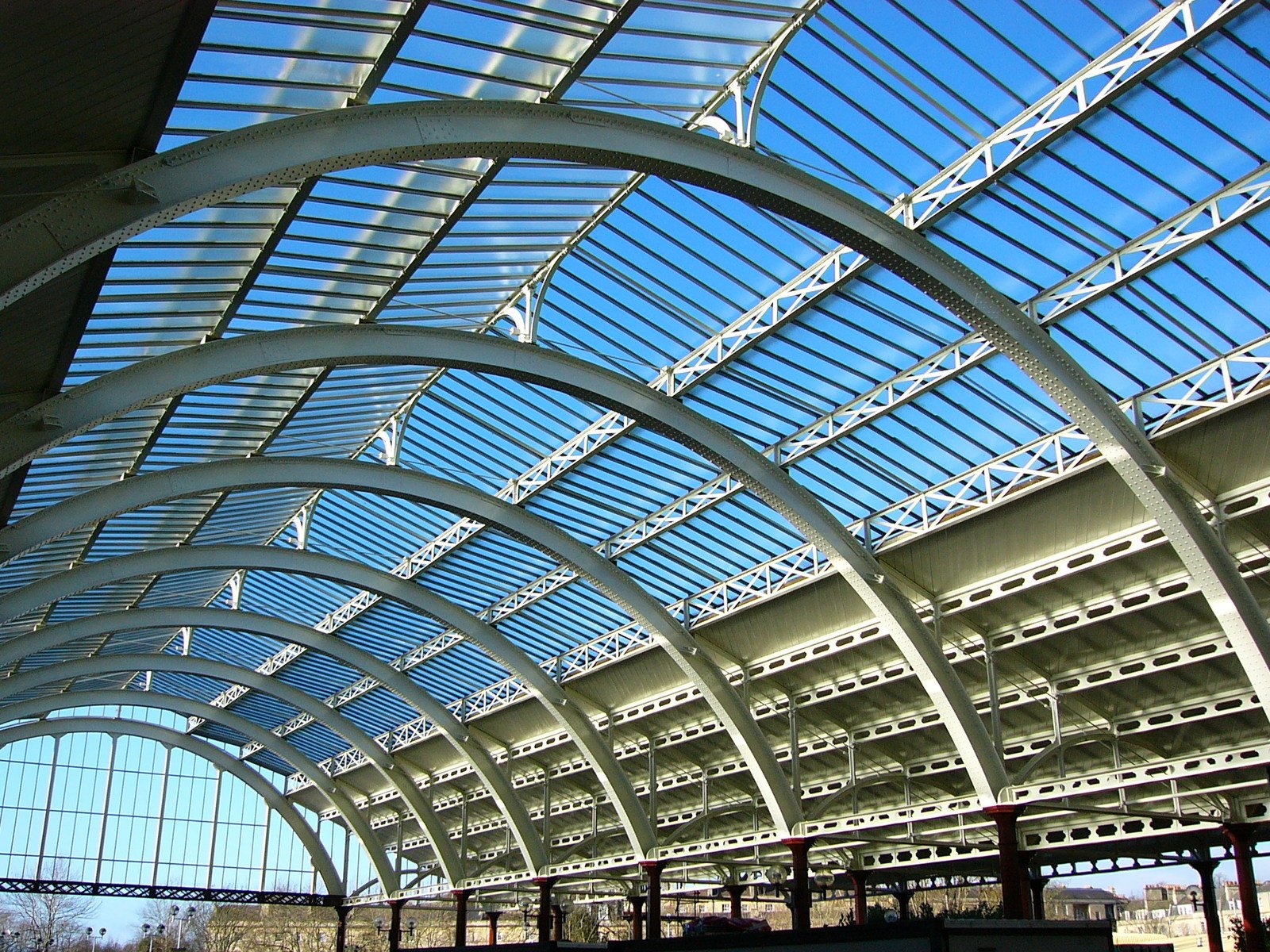 a train station that is sitting under a skylight