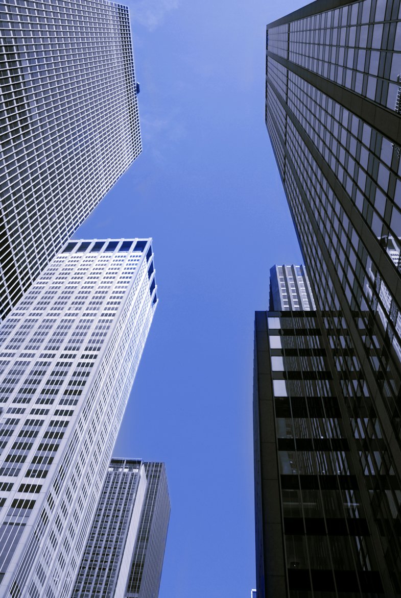 several tall buildings stand in front of blue sky