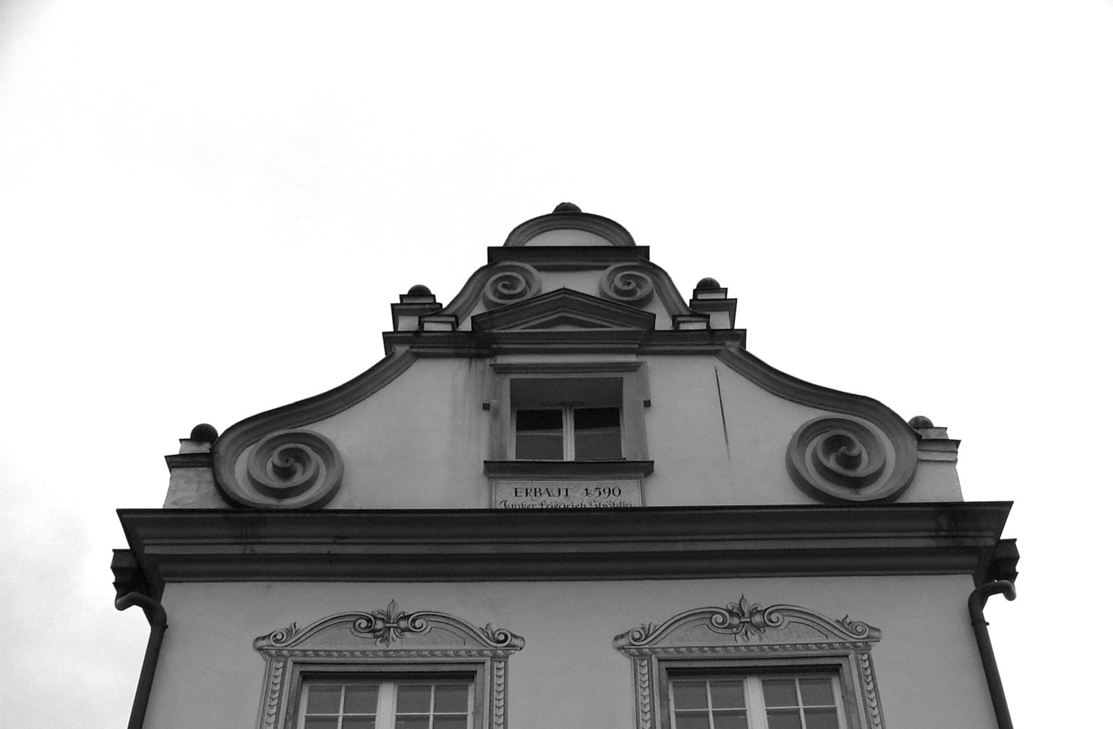 the top of a building has arched windows