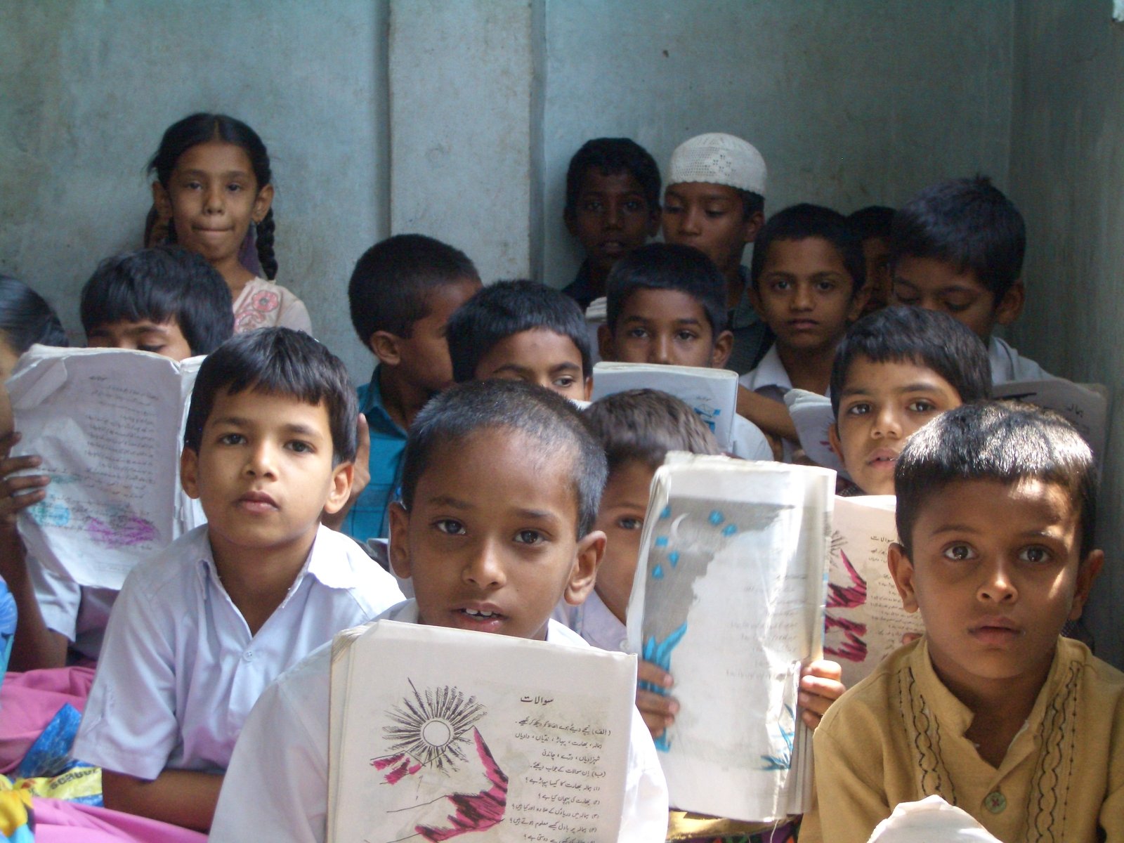 a group of children in school uniforms holding books