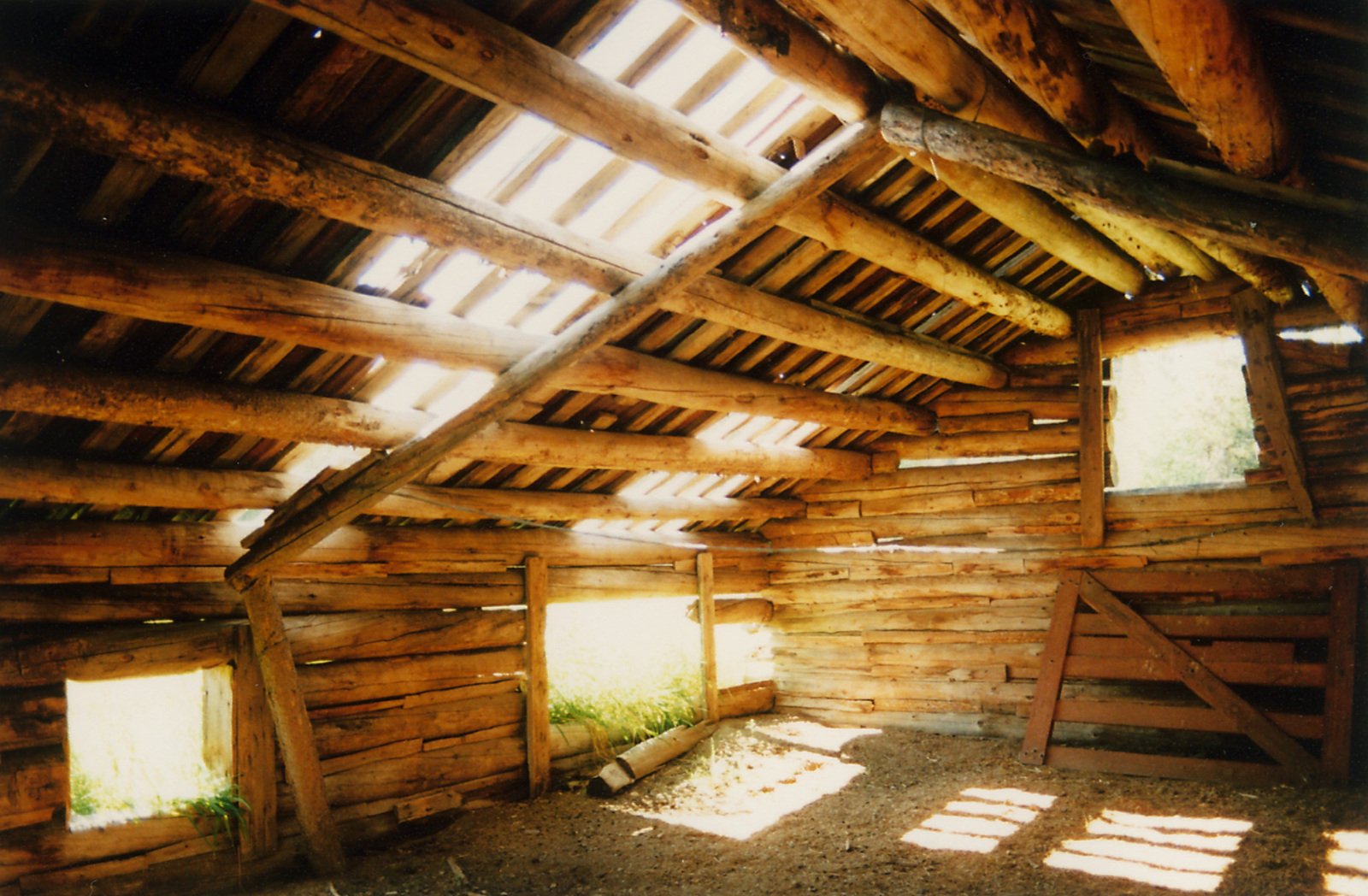 a barn interior with wood walls and windows