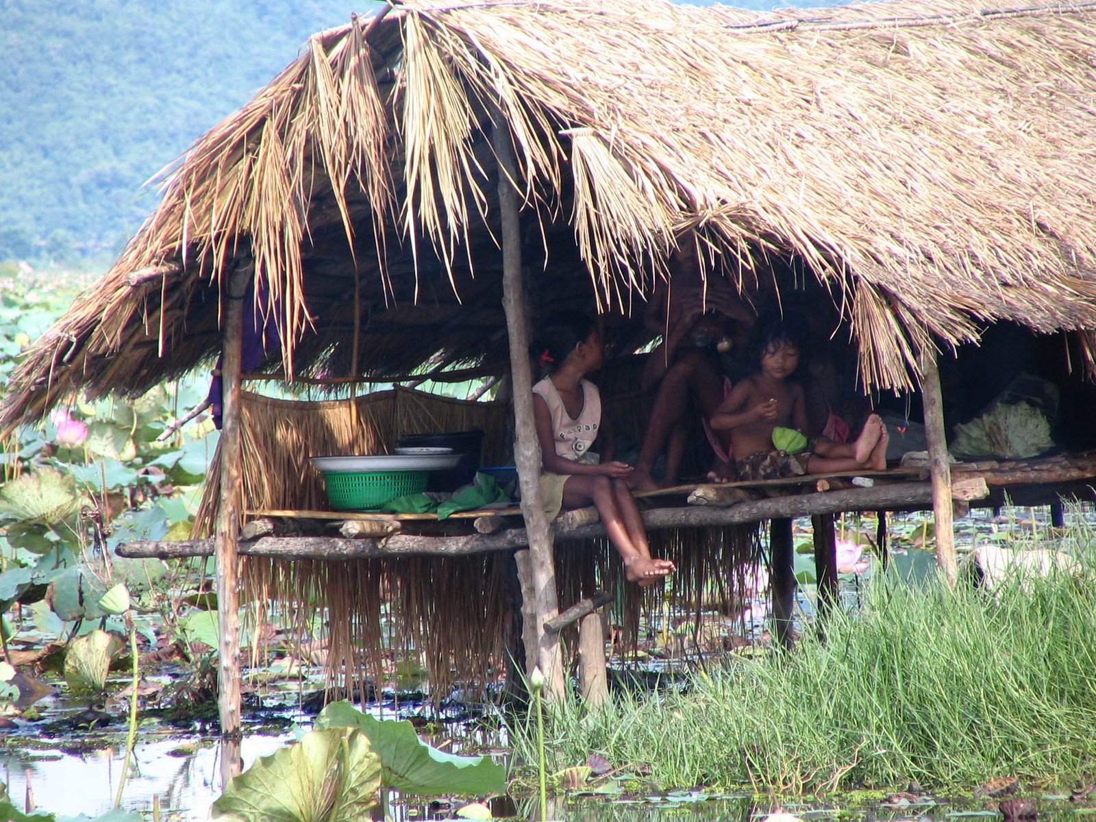 the people sit at the bottom of the hut